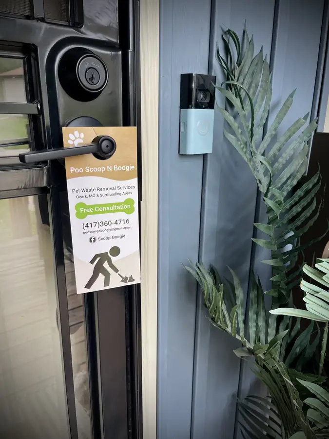 Poo Scoop N Boogie door hanger on a front door handle